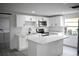 Modern kitchen with white shaker cabinets, quartz countertops, and a large island at 5813 N 15Th St, Tampa, FL 33610