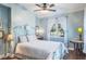 Bedroom with light blue walls, a ceiling fan and wrought iron bed at 602 Maryland Ave, Crystal Beach, FL 34681