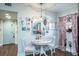 Bright dining area with charming white table and chairs at 602 Maryland Ave, Crystal Beach, FL 34681