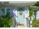 Charming teal front door accented by lush greenery at 602 Maryland Ave, Crystal Beach, FL 34681