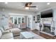 Bright living room featuring a fireplace, comfy seating, and hardwood floors at 602 Maryland Ave, Crystal Beach, FL 34681