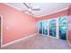 Spacious bedroom with light walls and access to a private patio at 7400 Sun Island S Dr # 104, South Pasadena, FL 33707