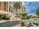 Beautiful high-rise building exterior with lush landscaping, decorative fountain, and circular driveway at 7400 Sun Island S Dr # 104, South Pasadena, FL 33707
