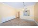 Bright dining room with tile flooring, custom cabinet, and a convenient pass-through window to the kitchen at 7400 Sun Island S Dr # 104, South Pasadena, FL 33707