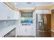 Modern kitchen features white cabinets, stainless steel appliances, and quartz countertops at 7400 Sun Island S Dr # 104, South Pasadena, FL 33707