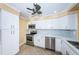 Modern kitchen with white cabinets, stainless steel appliances and tile backsplash at 7400 Sun Island S Dr # 104, South Pasadena, FL 33707