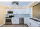 Updated kitchen with stainless steel appliances and light wood cabinets at 7400 Sun Island S Dr # 104, South Pasadena, FL 33707