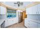 Modern kitchen with white cabinets, stainless steel appliances, and tile backsplash at 7400 Sun Island S Dr # 104, South Pasadena, FL 33707
