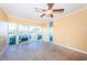 Bright living room with tiled floors, ceiling fan, and sliding glass doors leading to outdoor space at 7400 Sun Island S Dr # 104, South Pasadena, FL 33707