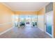 Bright living room with tiled floors, ceiling fan, and sliding glass doors leading to outdoor space at 7400 Sun Island S Dr # 104, South Pasadena, FL 33707