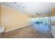 Spacious living room featuring tiled floors, a ceiling fan, and a sliding glass door to the balcony at 7400 Sun Island S Dr # 104, South Pasadena, FL 33707