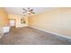 Open living room with tiled floors, ceiling fan, and an open bar area into the kitchen at 7400 Sun Island S Dr # 104, South Pasadena, FL 33707