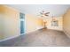 Open living room with tiled floors, ceiling fan, and an open bar area into the kitchen at 7400 Sun Island S Dr # 104, South Pasadena, FL 33707
