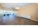 Spacious living room featuring tiled floors, a ceiling fan, and a sliding glass door to the balcony at 7400 Sun Island S Dr # 104, South Pasadena, FL 33707
