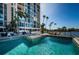 Community pool and spa area with lush tropical landscaping at 7400 Sun Island S Dr # 104, South Pasadena, FL 33707