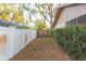 Backyard with white vinyl fence and green hedge at 8493 Cypress Lake Cir, Sarasota, FL 34243