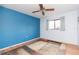 Bedroom with blue walls, ceiling fan and wood floors at 8493 Cypress Lake Cir, Sarasota, FL 34243