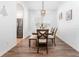 Charming dining room with wooden table and chairs, and view into the kitchen at 8601 Sandy Plains Dr, Riverview, FL 33578