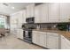 Modern kitchen featuring white cabinets and granite countertops at 12610 Sorrento Way # 102, Bradenton, FL 34211