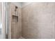 Clean shower with neutral tile and handheld showerhead at 12610 Sorrento Way # 102, Bradenton, FL 34211