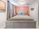 Bedroom with gray bed, coral wall, and ocean-themed decor at 4801 14Th S Ave, St Petersburg, FL 33711