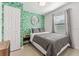 Bedroom with tropical print wall and gray bedding at 4801 14Th S Ave, St Petersburg, FL 33711