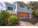 Side of the house with beach mural and fenced yard at 4801 14Th S Ave, St Petersburg, FL 33711