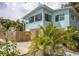Charming light blue house with a yellow door, and palm trees at 4801 14Th S Ave, St Petersburg, FL 33711