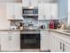 Modern kitchen with white cabinets, granite counters, and stainless steel appliances at 4801 14Th S Ave, St Petersburg, FL 33711