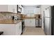 Modern kitchen with white cabinets, granite counters, and stainless steel appliances at 4801 14Th S Ave, St Petersburg, FL 33711