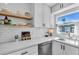 Bright, white kitchen with open shelving, subway tile backsplash, and modern fixtures at 10216 63Rd Ave, Seminole, FL 33772