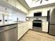 Modern kitchen with white shaker cabinets and stainless steel appliances at 126 1St E St # 209, Tierra Verde, FL 33715