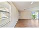 Bright living room with wood-look floors and sliding glass door at 129 Camphor Cir # F, Oldsmar, FL 34677