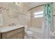 Bathroom with beige tile, a white bathtub, and a modern vanity at 1426 Jasmine Ct, Clearwater, FL 33756