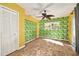 Bedroom with tropical leaf wallpaper and tiled floor at 1426 Jasmine Ct, Clearwater, FL 33756