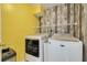 Laundry room with Maytag washer and dryer, and stylish wall decor at 1426 Jasmine Ct, Clearwater, FL 33756