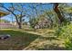 Spacious backyard with lush grass and mature trees at 1530 22Nd S Ave, St Petersburg, FL 33705