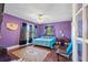 Purple bedroom with hardwood floors, a queen bed, and large windows at 1530 22Nd S Ave, St Petersburg, FL 33705