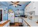 White kitchen cabinets, wood countertops and a ceiling fan at 1530 22Nd S Ave, St Petersburg, FL 33705