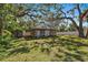 Detached outbuilding with garage door and storage shed in backyard at 1530 22Nd S Ave, St Petersburg, FL 33705