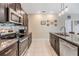 Modern kitchen with granite countertops and stainless steel appliances at 15611 Demory Point Pl, Sun City Center, FL 33573