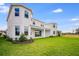 Expansive backyard features lush greenery, showcasing the home's outdoor living potential and privacy at 1979 Longliner Loop, Wesley Chapel, FL 33543