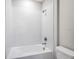 Clean bathroom featuring a tub with tiled wall surround, and a neutral color palette at 1979 Longliner Loop, Wesley Chapel, FL 33543