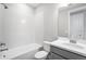 Clean bathroom featuring a tub with tiled wall surround, single sink vanity, and neutral color palette at 1979 Longliner Loop, Wesley Chapel, FL 33543