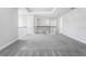 A view of a bedroom and hallway area featuring neutral gray walls, white trim and neutral gray carpet at 1979 Longliner Loop, Wesley Chapel, FL 33543