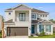 Charming two-story home featuring a balcony, a front-facing garage, and attractive architectural details at 1979 Longliner Loop, Wesley Chapel, FL 33543