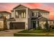 Charming two-story home featuring a balcony, a front-facing garage, and attractive architectural details at 1979 Longliner Loop, Wesley Chapel, FL 33543