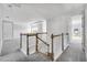 This hallway features neutral walls and plush carpet leading to the bedrooms and living spaces at 1979 Longliner Loop, Wesley Chapel, FL 33543