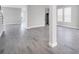 This living room has an open floor plan, wood tile flooring and large windows for natural light at 1979 Longliner Loop, Wesley Chapel, FL 33543