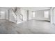 Spacious living room featuring gray-tone wood-look tile flooring, neutral walls, and bright natural light at 1979 Longliner Loop, Wesley Chapel, FL 33543